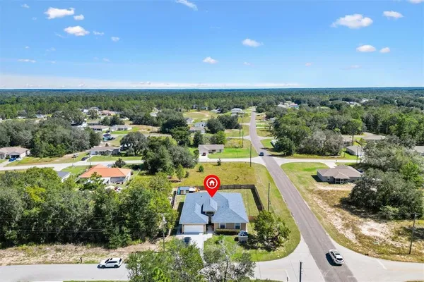 an aerial view of a houses with a swimming pool
