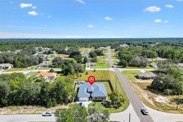 an aerial view of a houses with a swimming pool