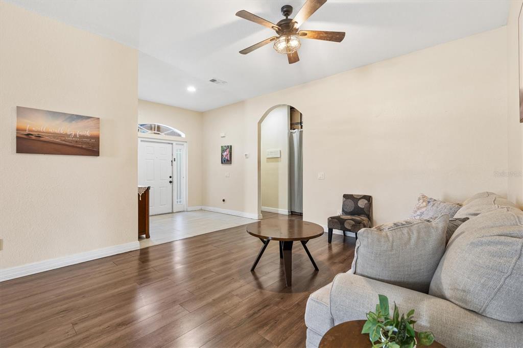 227 Locust Pass Course Ocala, FL 34472 - Photo 7 of 41 a living room with furniture and a wooden floor