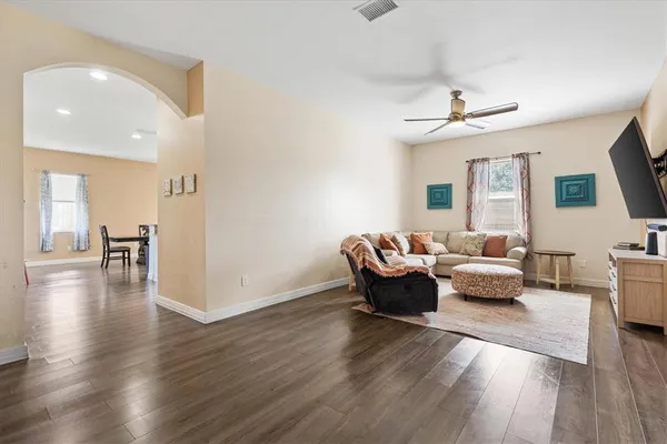 a living room with furniture and a wooden floor