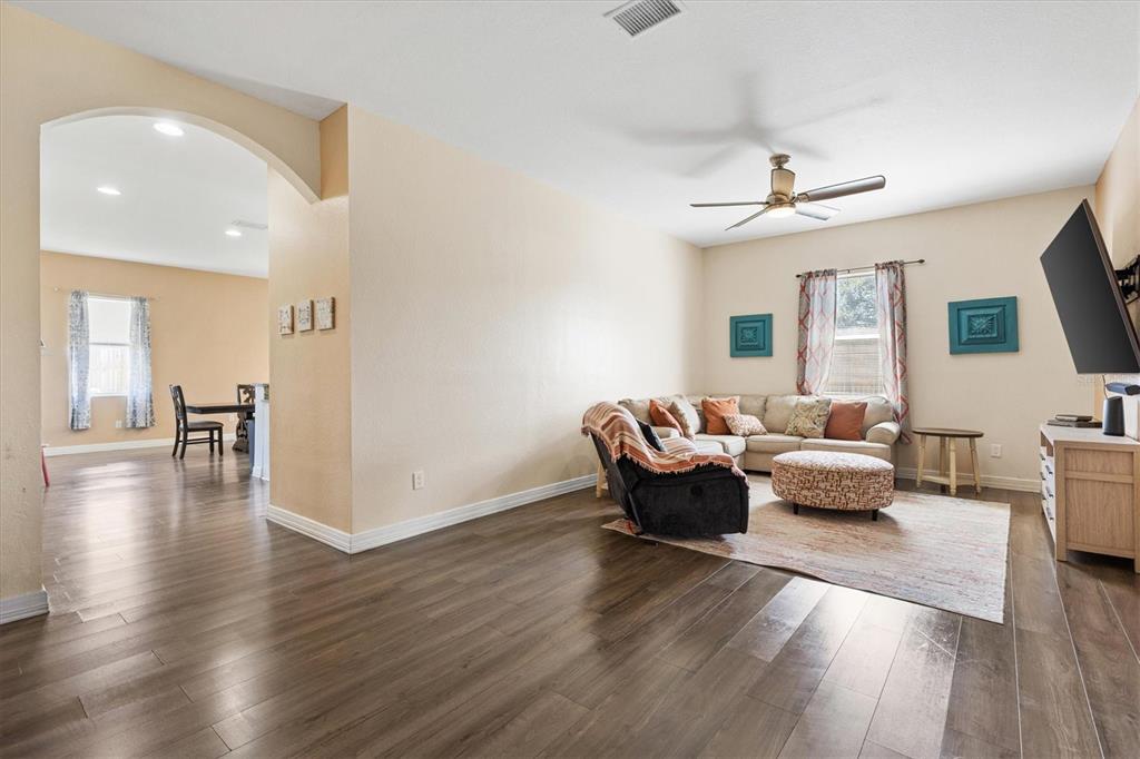 227 Locust Pass Course Ocala, FL 34472 - Photo 8 of 41 a living room with furniture and a wooden floor