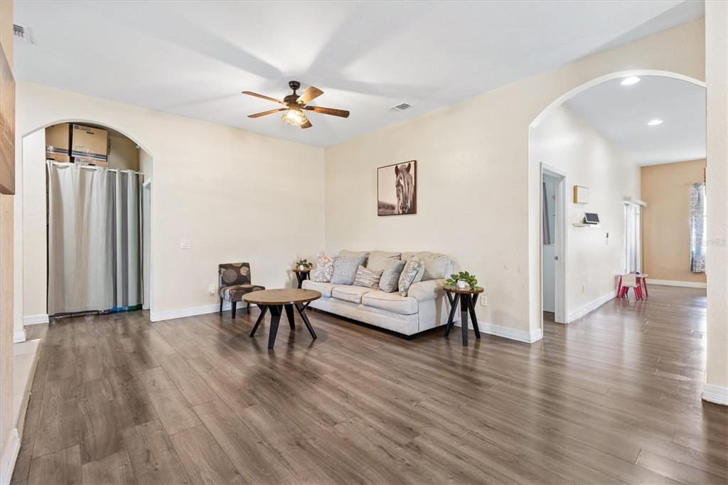 227 Locust Pass Course Ocala, FL 34472 - Photo 9 of 41 a living room with furniture and a wooden floor