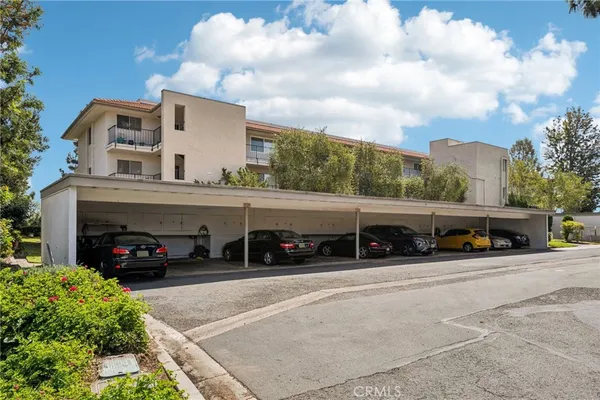 a view of a cars park in front of building