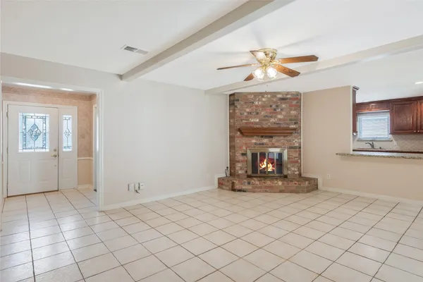 a view of a livingroom with a fireplace and window
