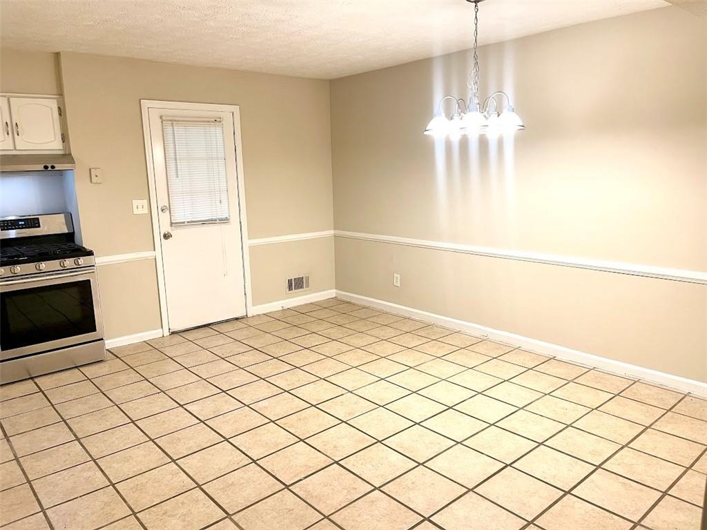 2611 Golfview Terrace Southeast Conyers, GA 30013 - Photo 7 of 22 a bedroom with a bed and a chandelier