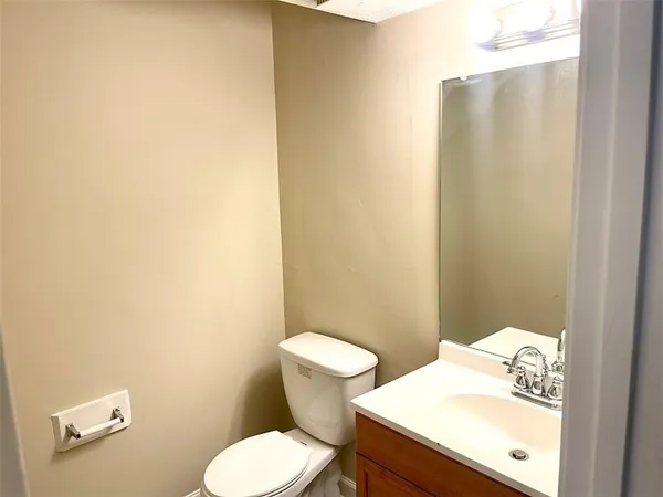 a white toilet sitting next to a bathroom sink