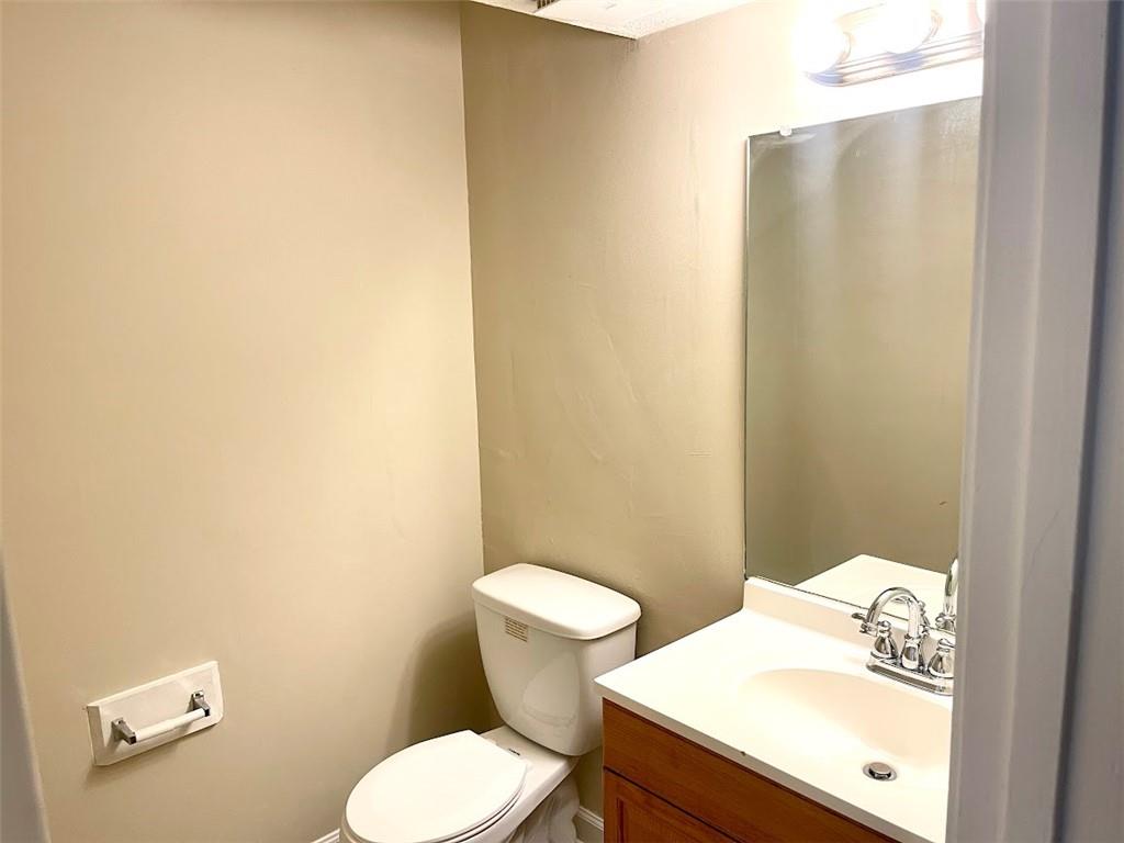 2611 Golfview Terrace Southeast Conyers, GA 30013 - Photo 9 of 22 a white toilet sitting next to a bathroom sink