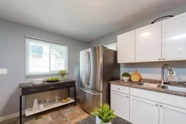 a kitchen with a refrigerator and a sink