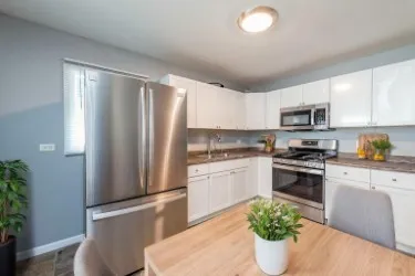 a kitchen with stainless steel appliances granite countertop a refrigerator sink and stove