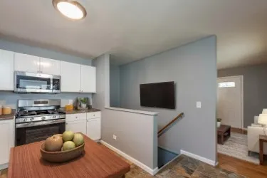 a kitchen with a sink a stove and cabinets