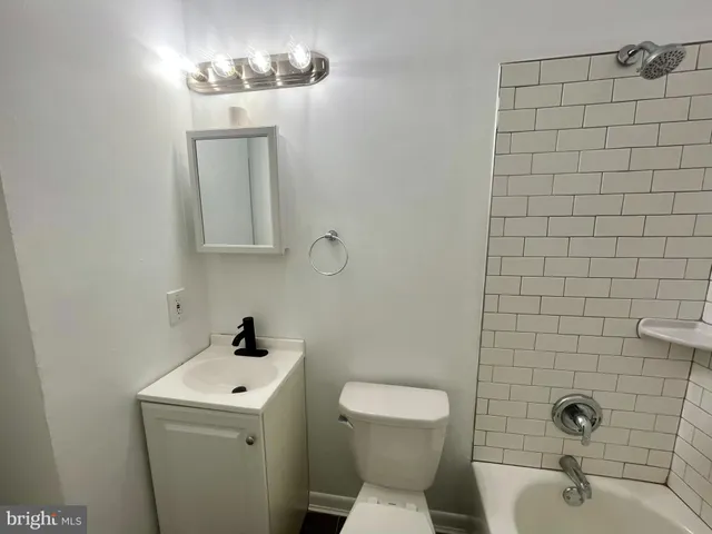 a view of a room with wooden floor and bench