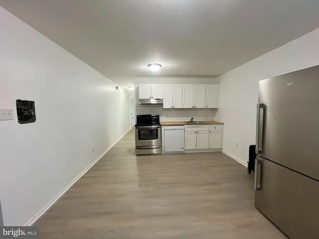 a kitchen with stainless steel appliances granite countertop a stove and a sink