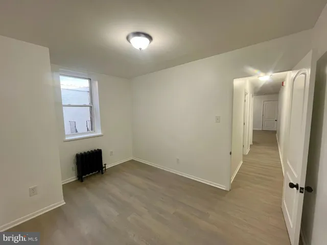 an empty room with wooden floor