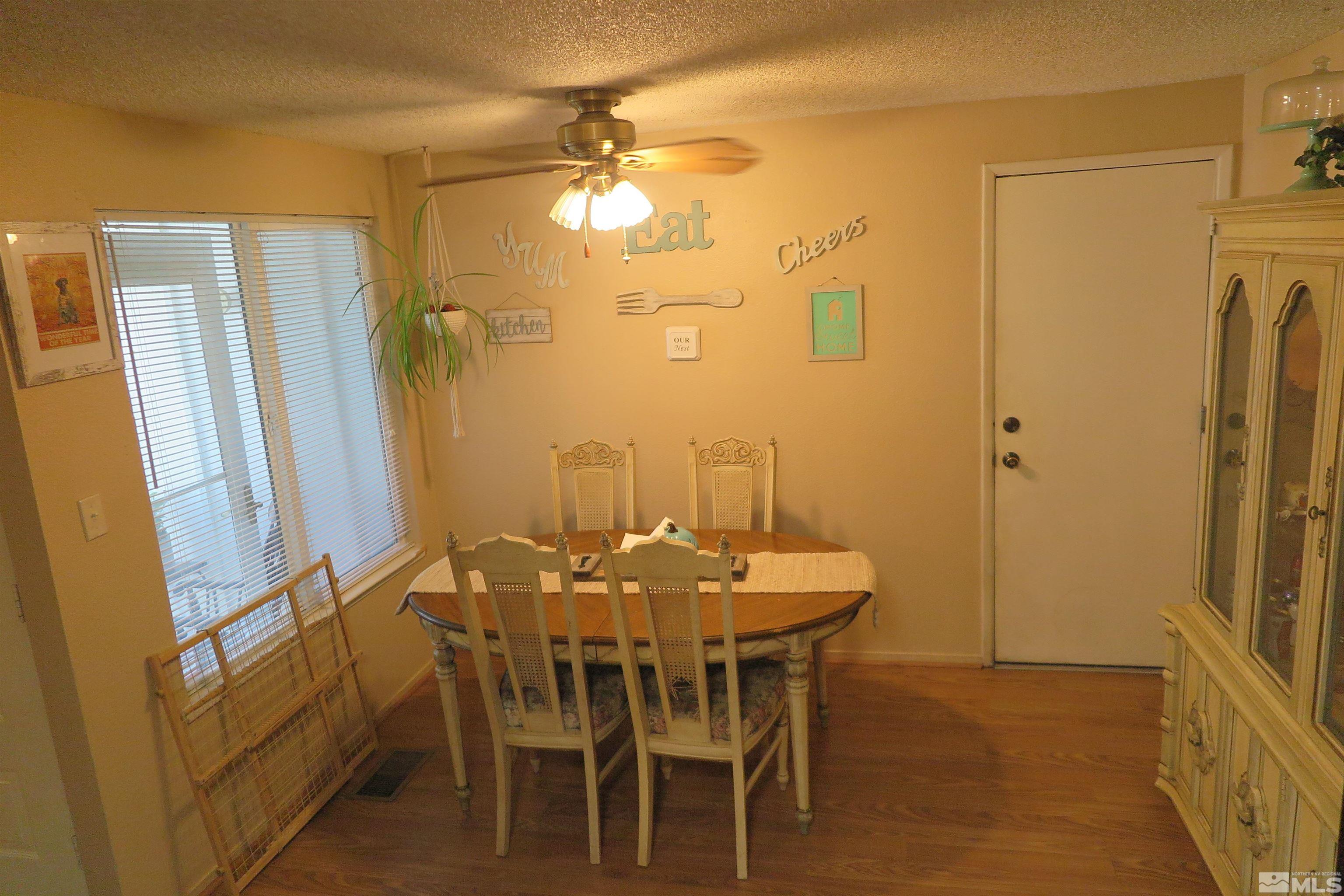 6825 Flower Street Reno, NV 89506 - Photo 15 of 35 a view of a dining room with furniture and a chandelier