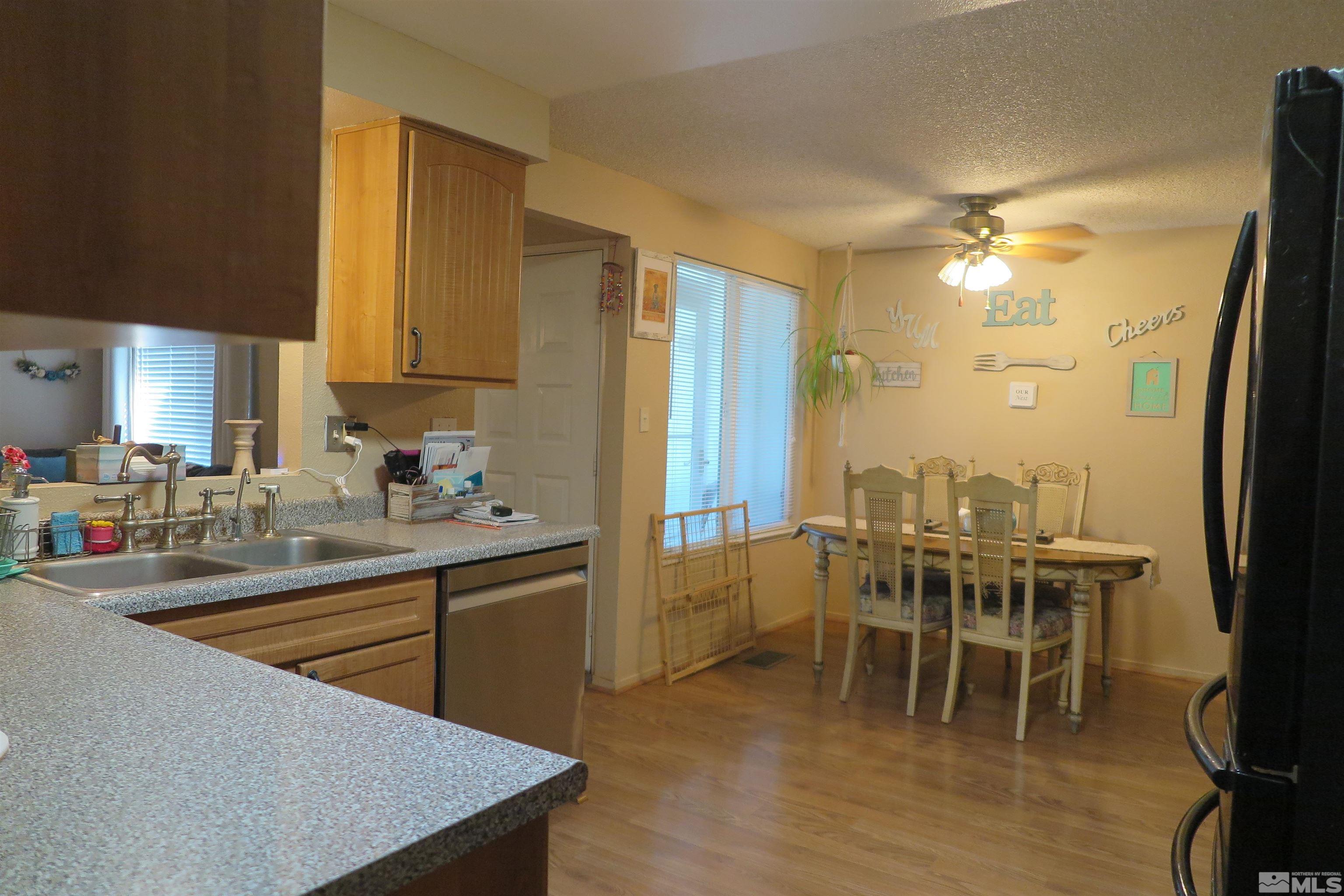 6825 Flower Street Reno, NV 89506 - Photo 16 of 35 a kitchen with a table chairs sink and cabinets