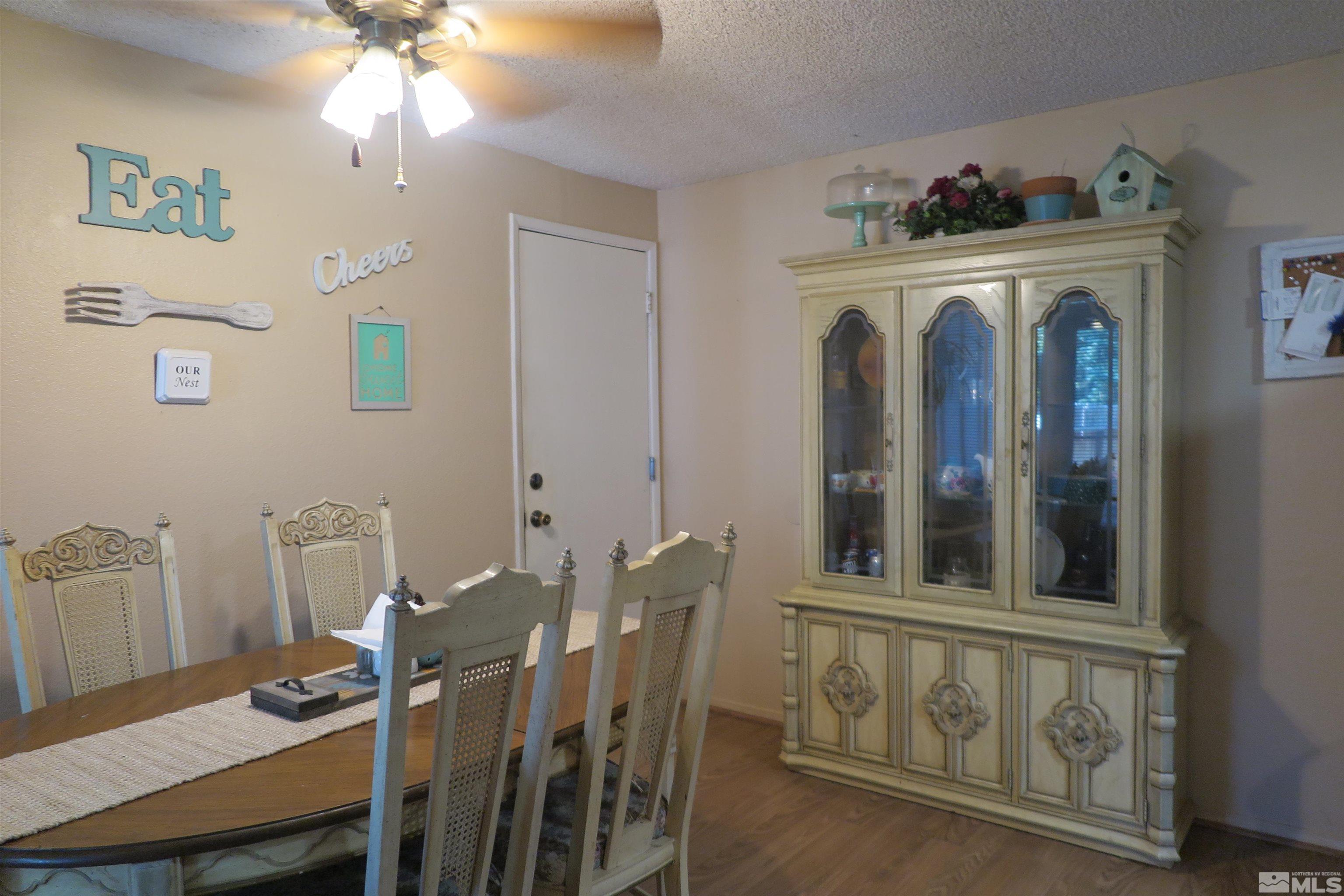 6825 Flower Street Reno, NV 89506 - Photo 17 of 35 a view of a dining room with furniture and chandelier