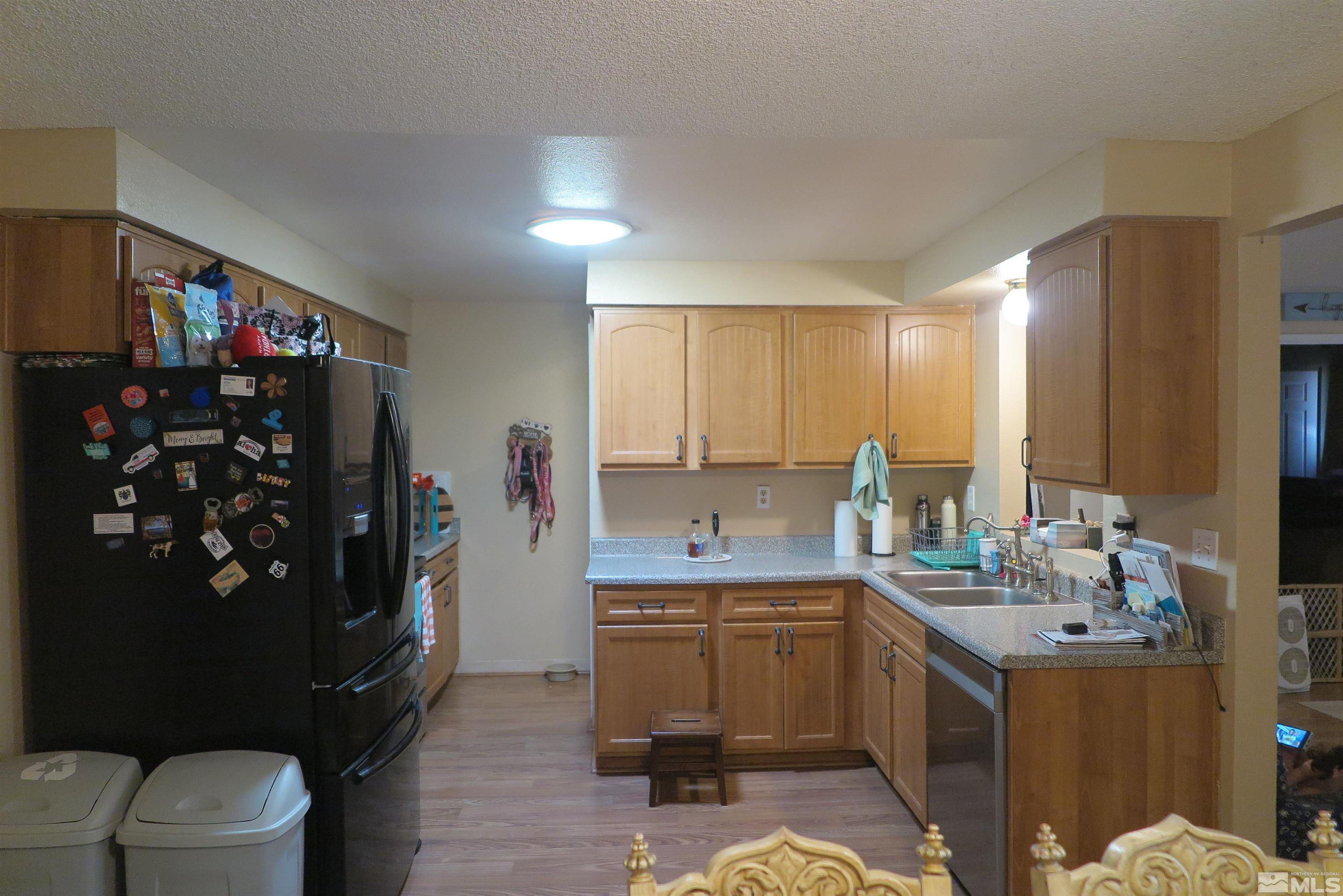 6825 Flower Street Reno, NV 89506 - Photo 18 of 35 a kitchen with a sink refrigerator and cabinets