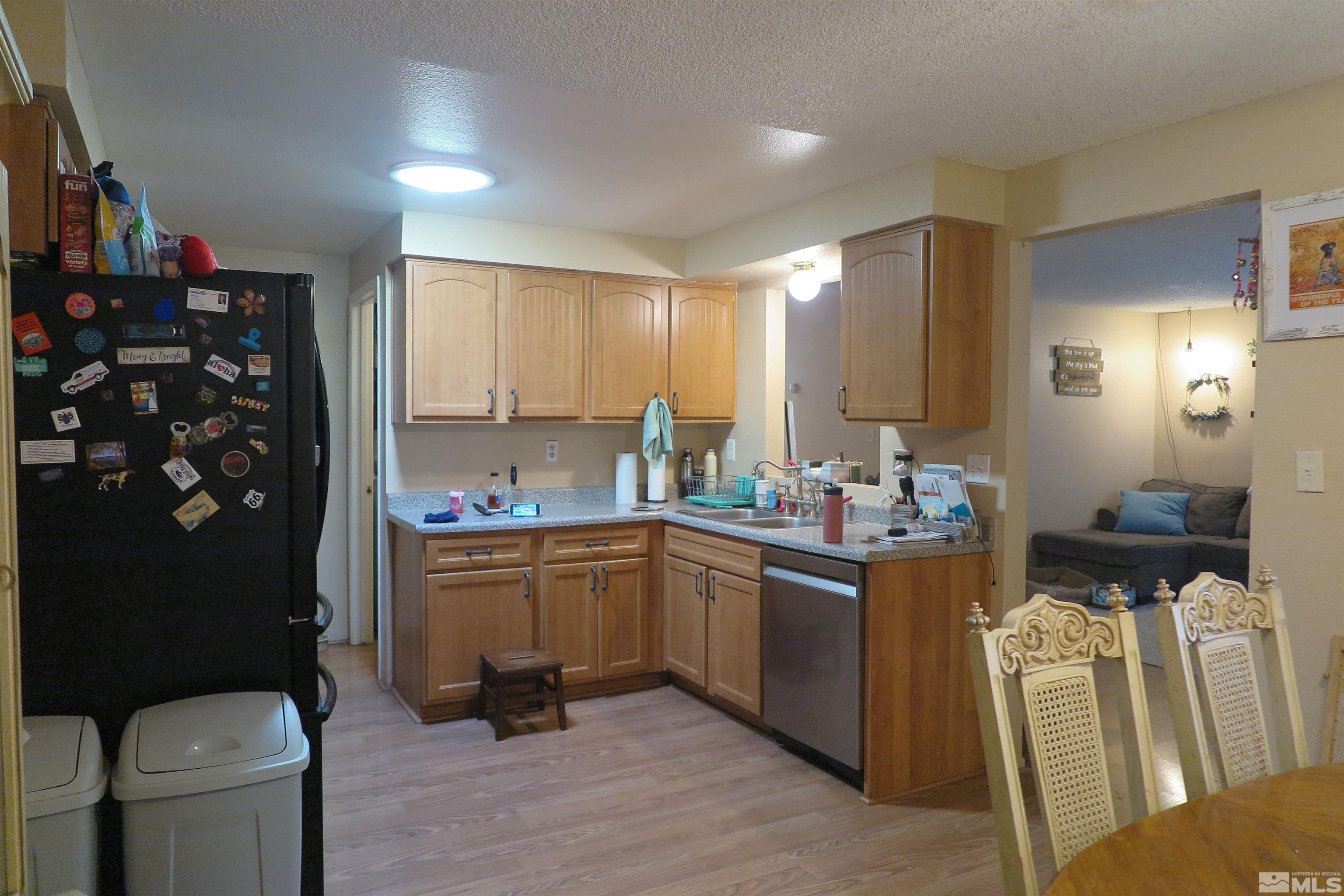 6825 Flower Street Reno, NV 89506 - Photo 19 of 35 a kitchen with stainless steel appliances granite countertop a sink and cabinets