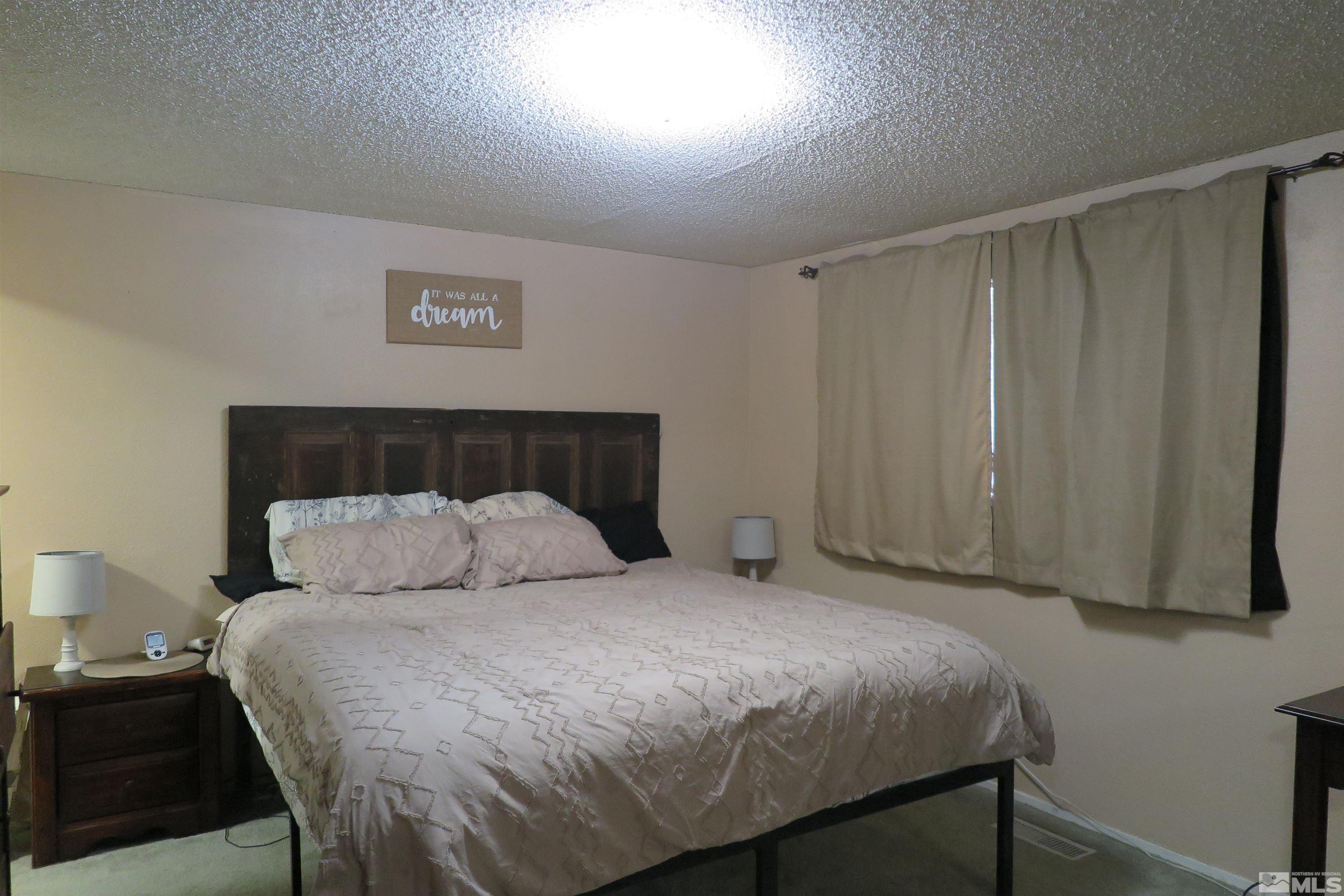 6825 Flower Street Reno, NV 89506 - Photo 25 of 35 a bedroom with a bed and a window