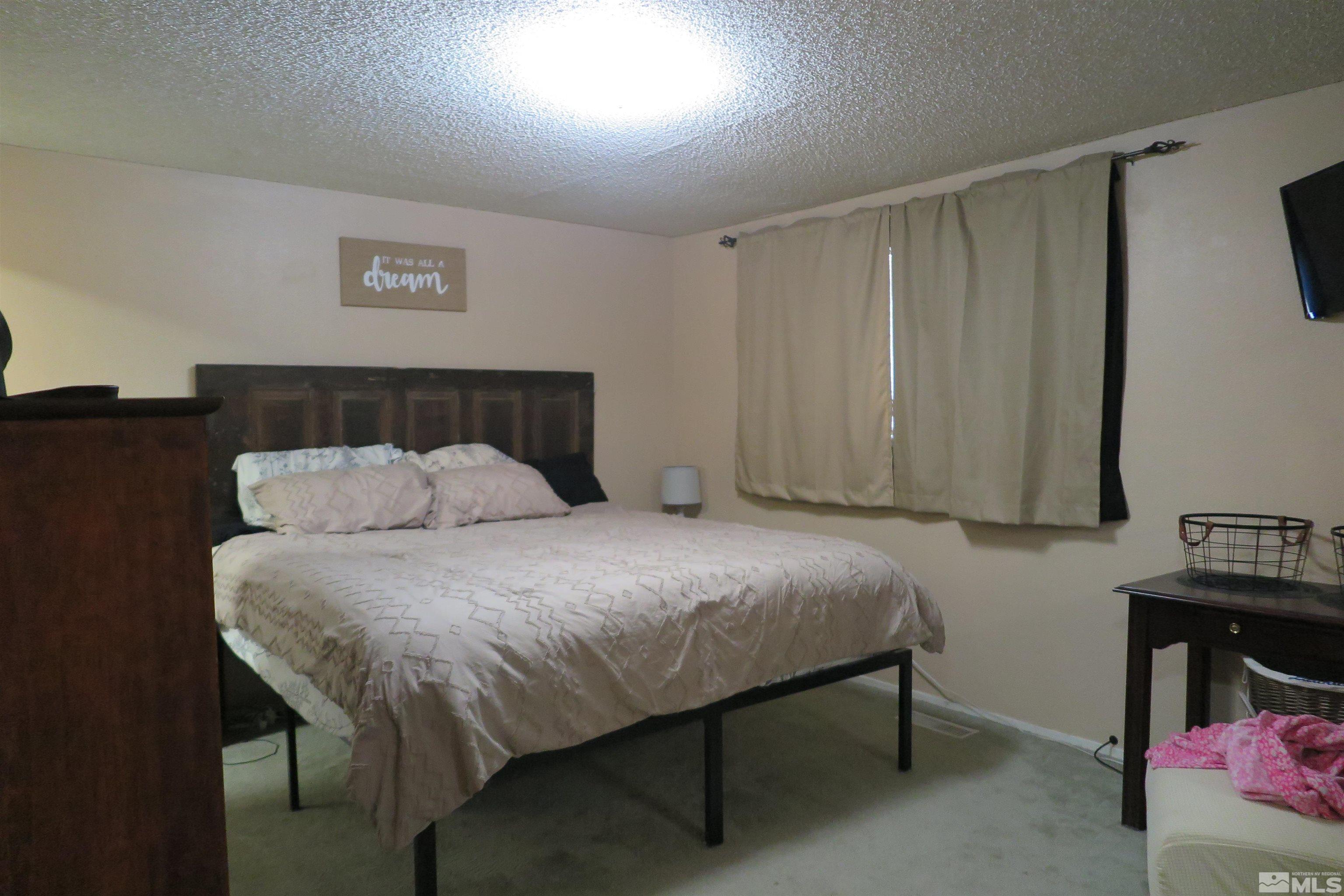 6825 Flower Street Reno, NV 89506 - Photo 27 of 35 a bed sitting in a bedroom next to a window