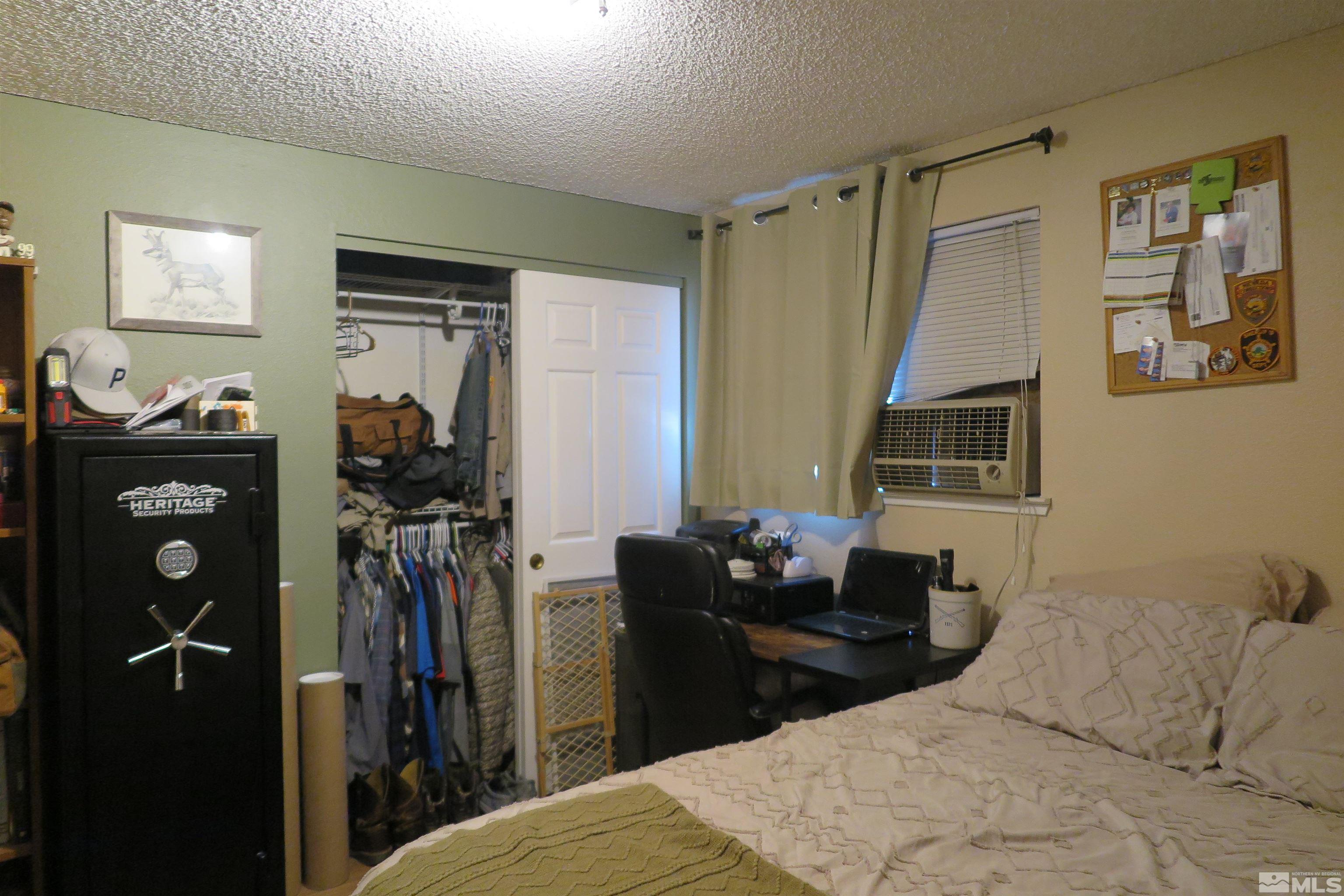 6825 Flower Street Reno, NV 89506 - Photo 28 of 35 a bedroom with a bed and a dresser