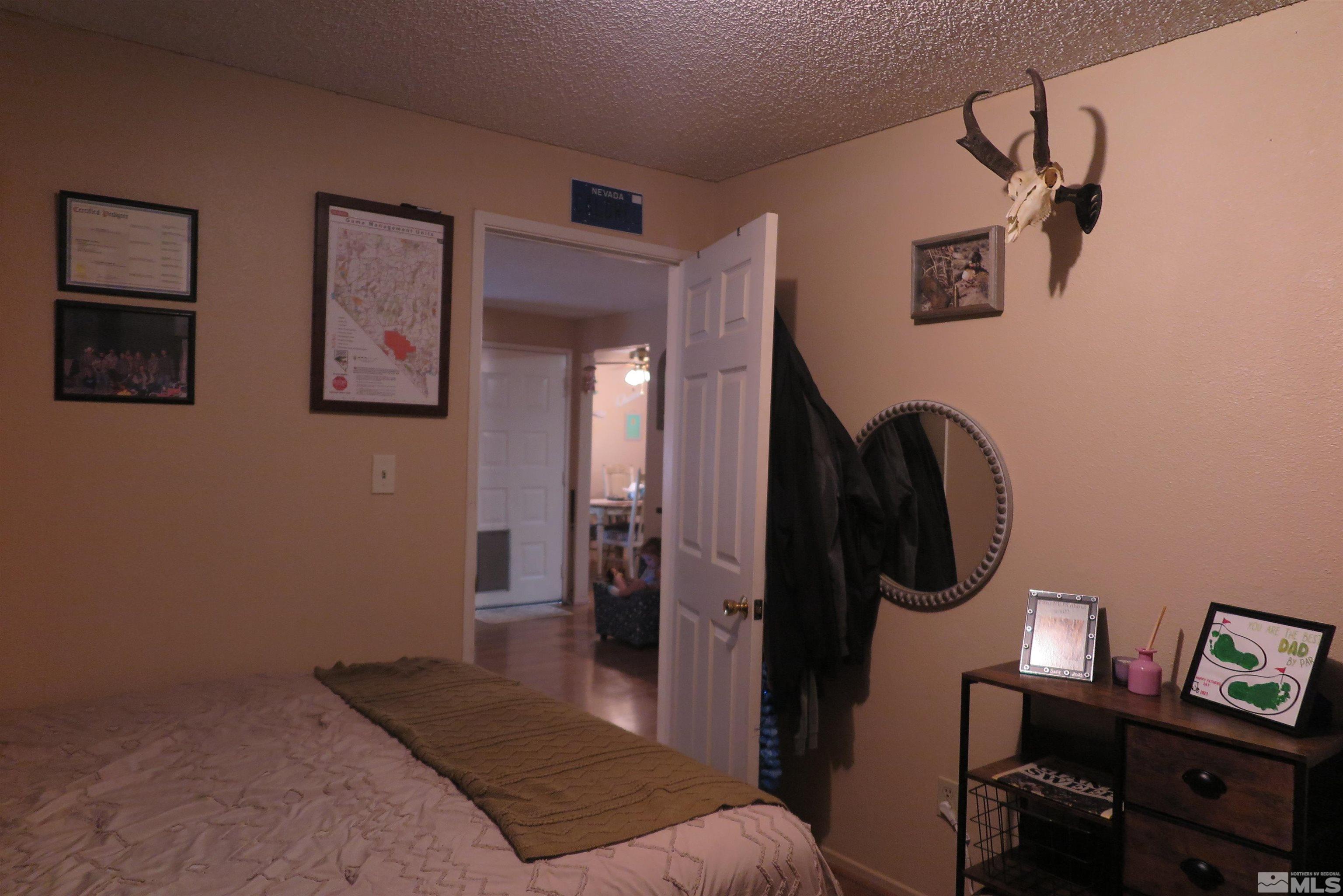 6825 Flower Street Reno, NV 89506 - Photo 29 of 35 a bedroom with a bed and a mirror