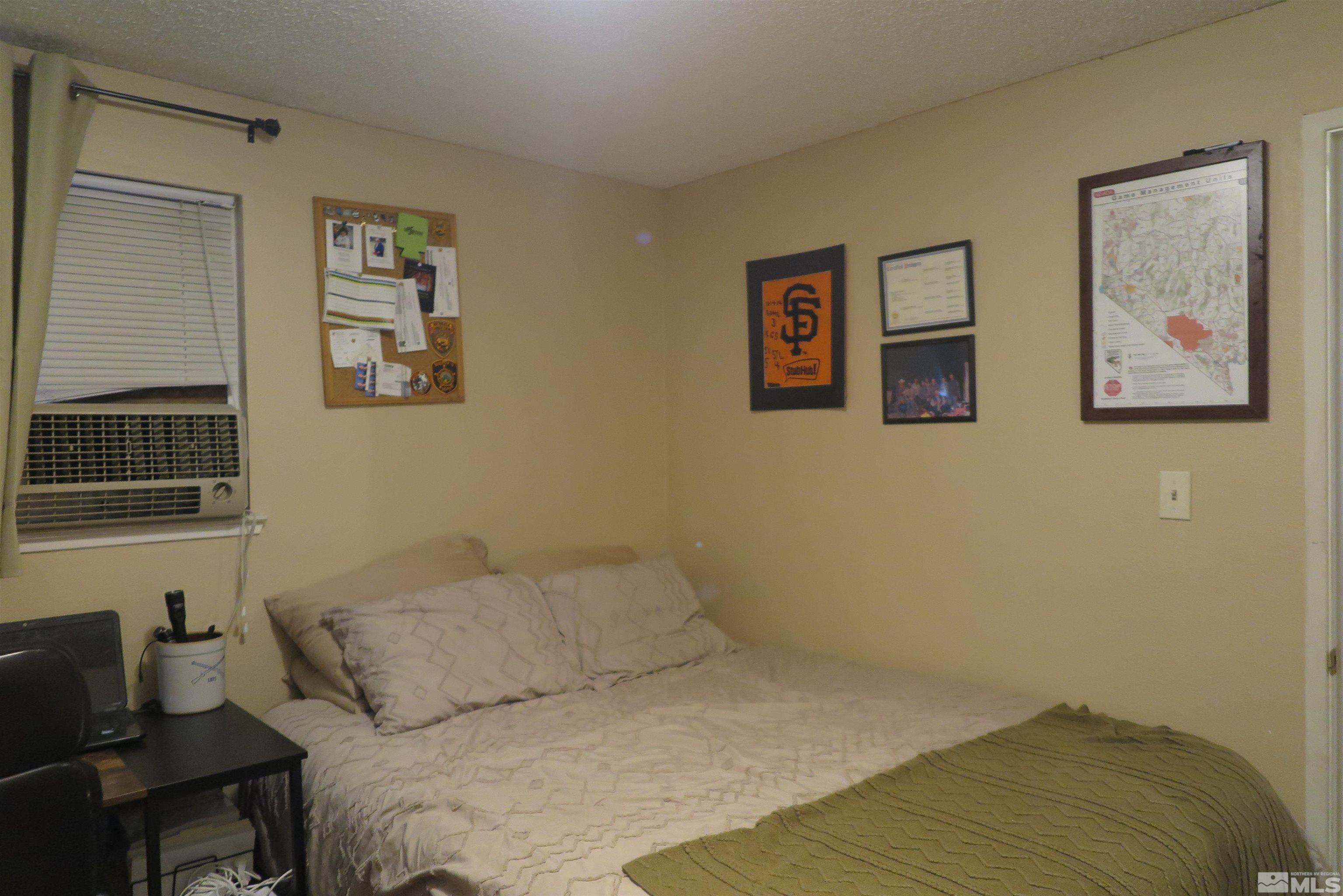 6825 Flower Street Reno, NV 89506 - Photo 30 of 35 a bedroom with a bed and a couch