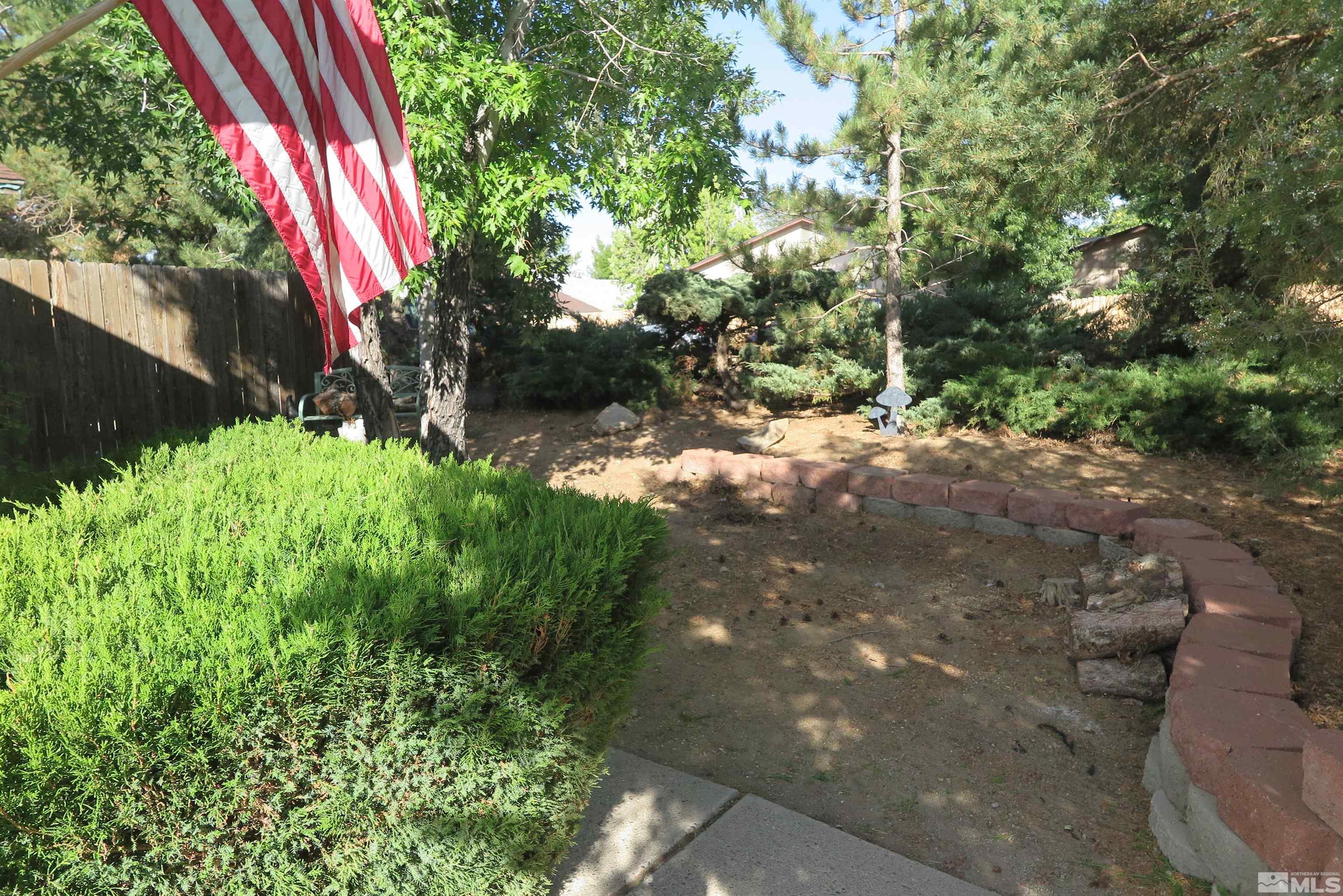 6825 Flower Street Reno, NV 89506 - Photo 34 of 35 a view of a yard with plants and a bench