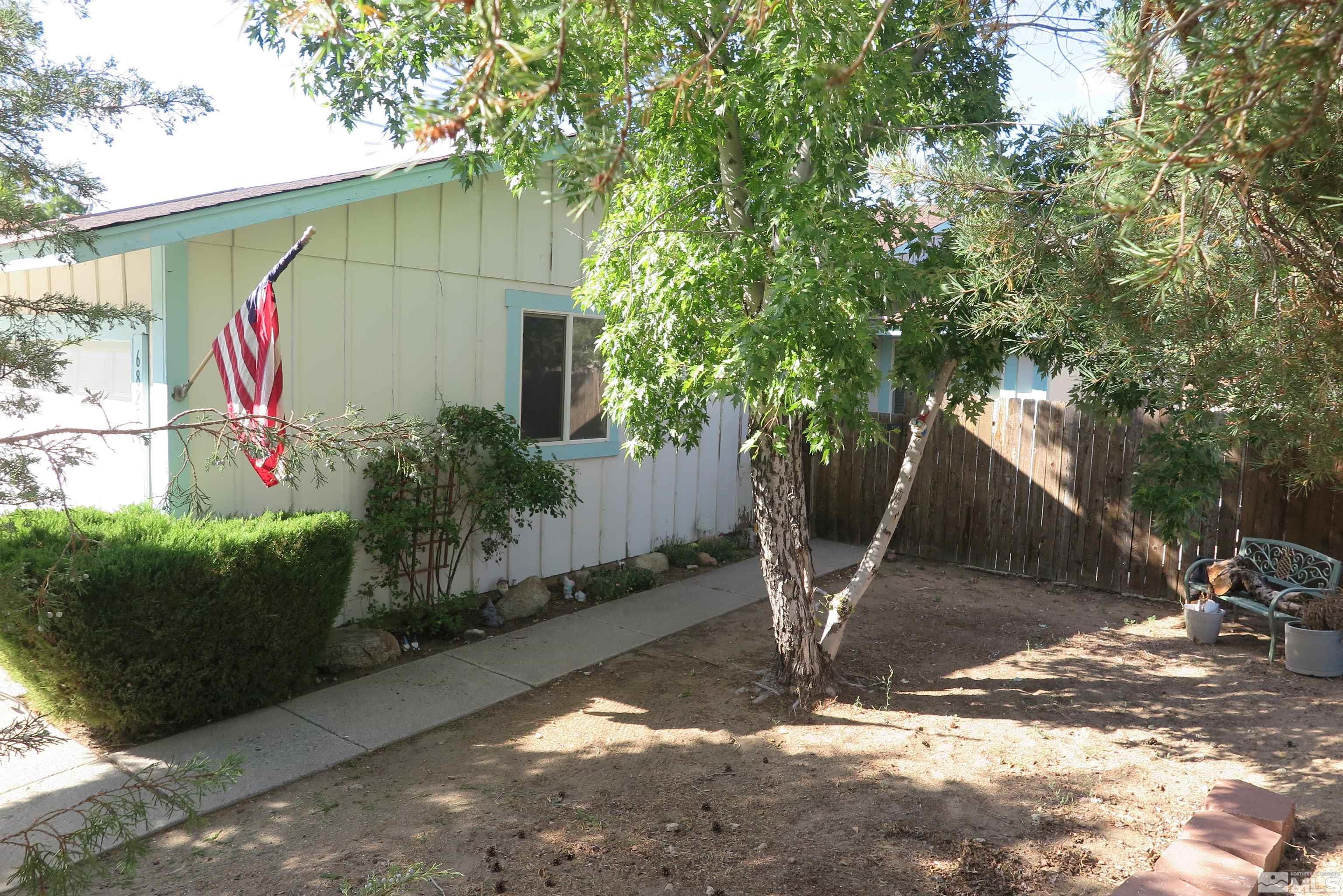 6825 Flower Street Reno, NV 89506 - Photo 5 of 35 a view of a house with a tree in the background