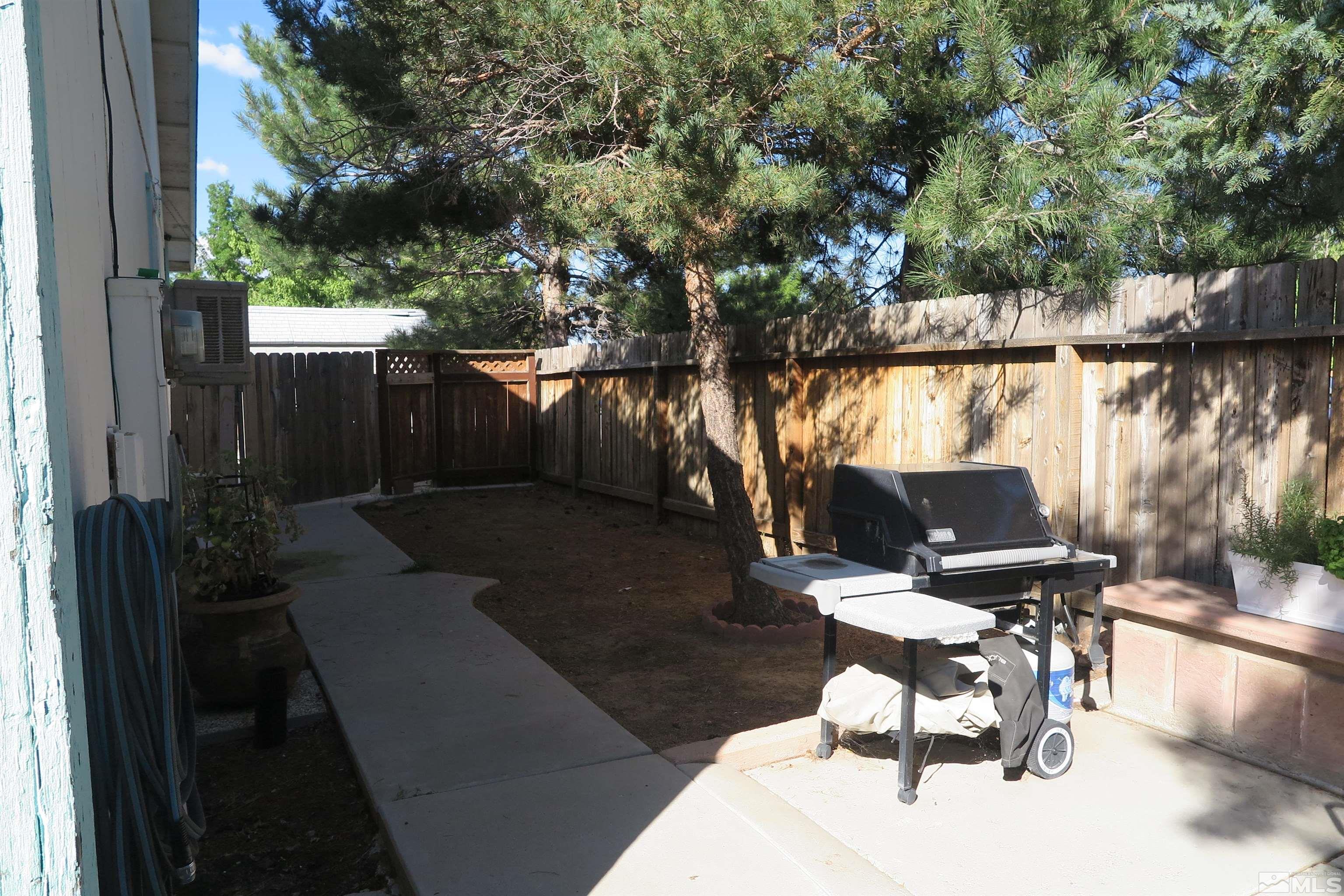 6825 Flower Street Reno, NV 89506 - Photo 6 of 35 a view of a patio with table and chairs and potted plants