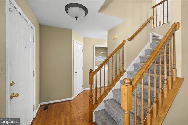 a view of an entryway with wooden floor and stairs