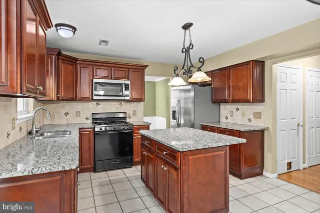 a view of an empty room with a window and fireplace