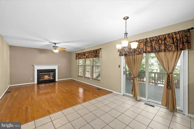a view of an empty room with a fireplace and a window