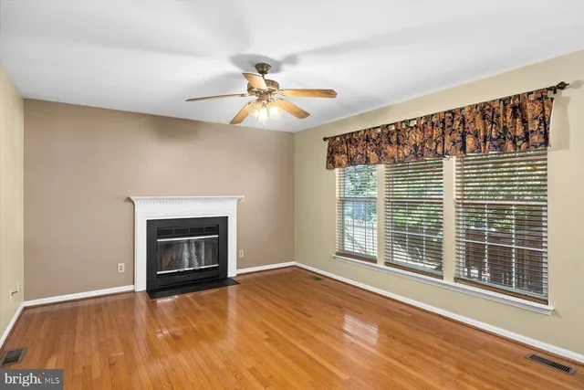 a open kitchen with wooden floors and a fireplace
