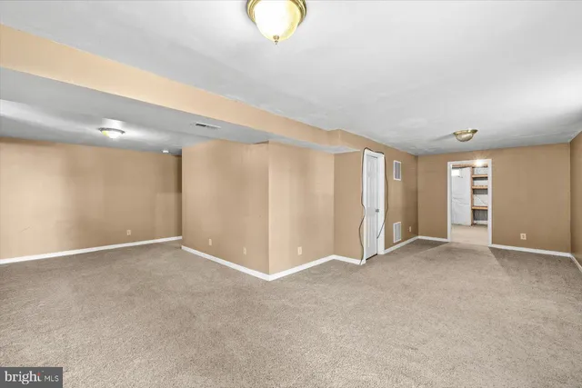 a view of a hallway with windows and closet