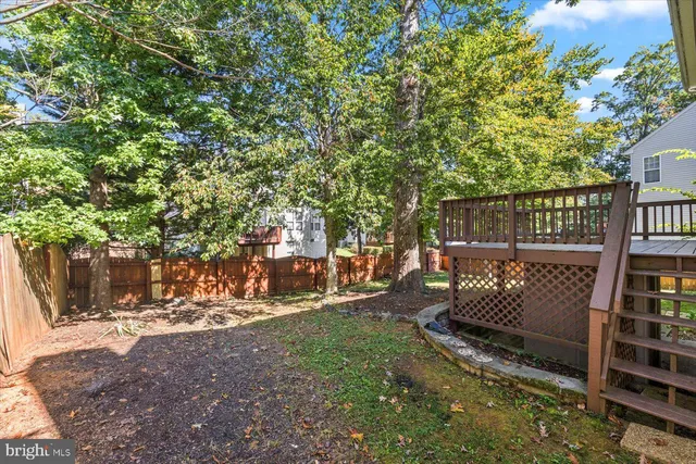 a view of a house with a yard and tree