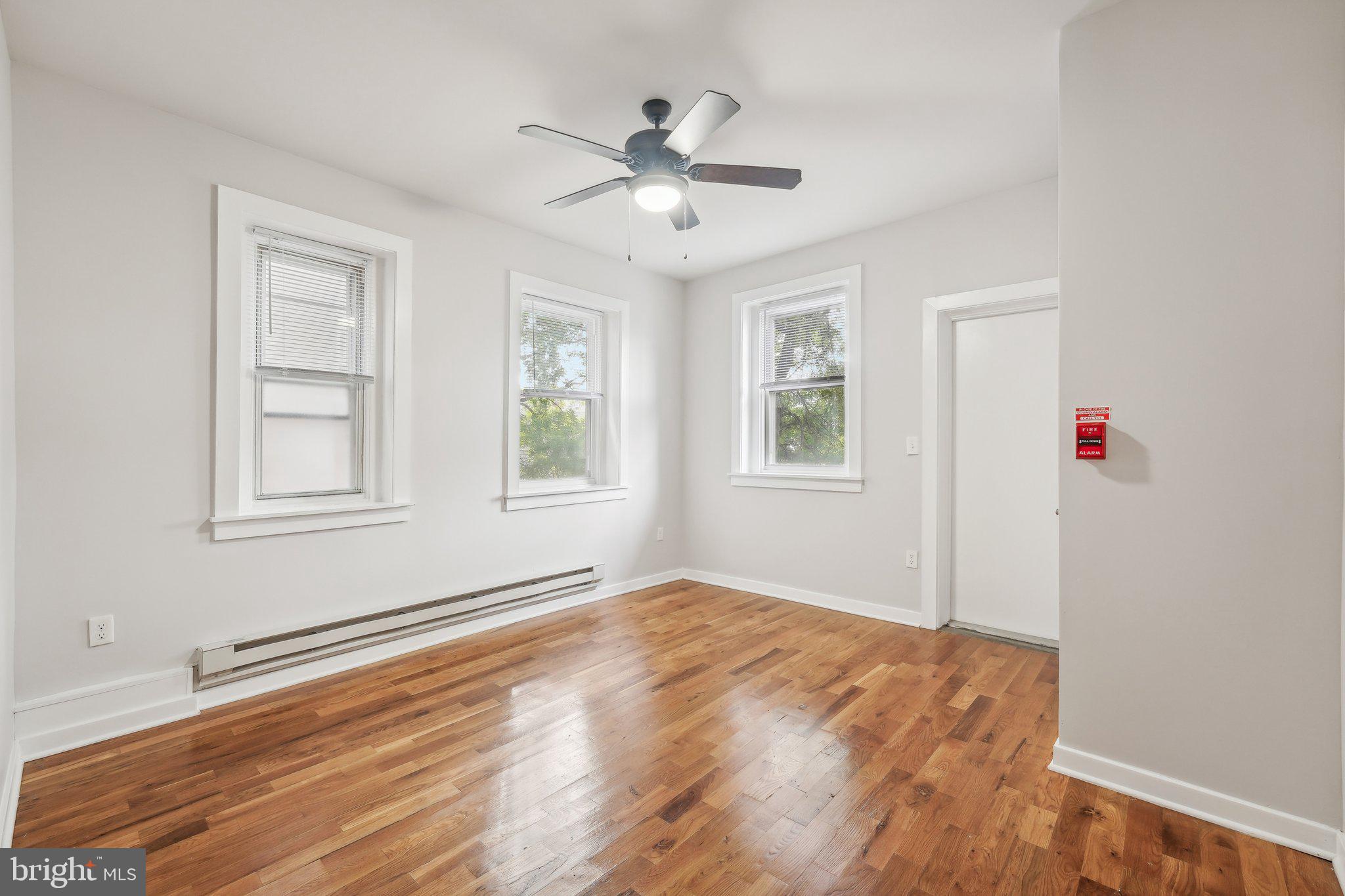 4300 Chestnut Street, Unit 2 Philadelphia, PA 19104 - Photo 16 of 30 a view of an empty room with window and wooden floor