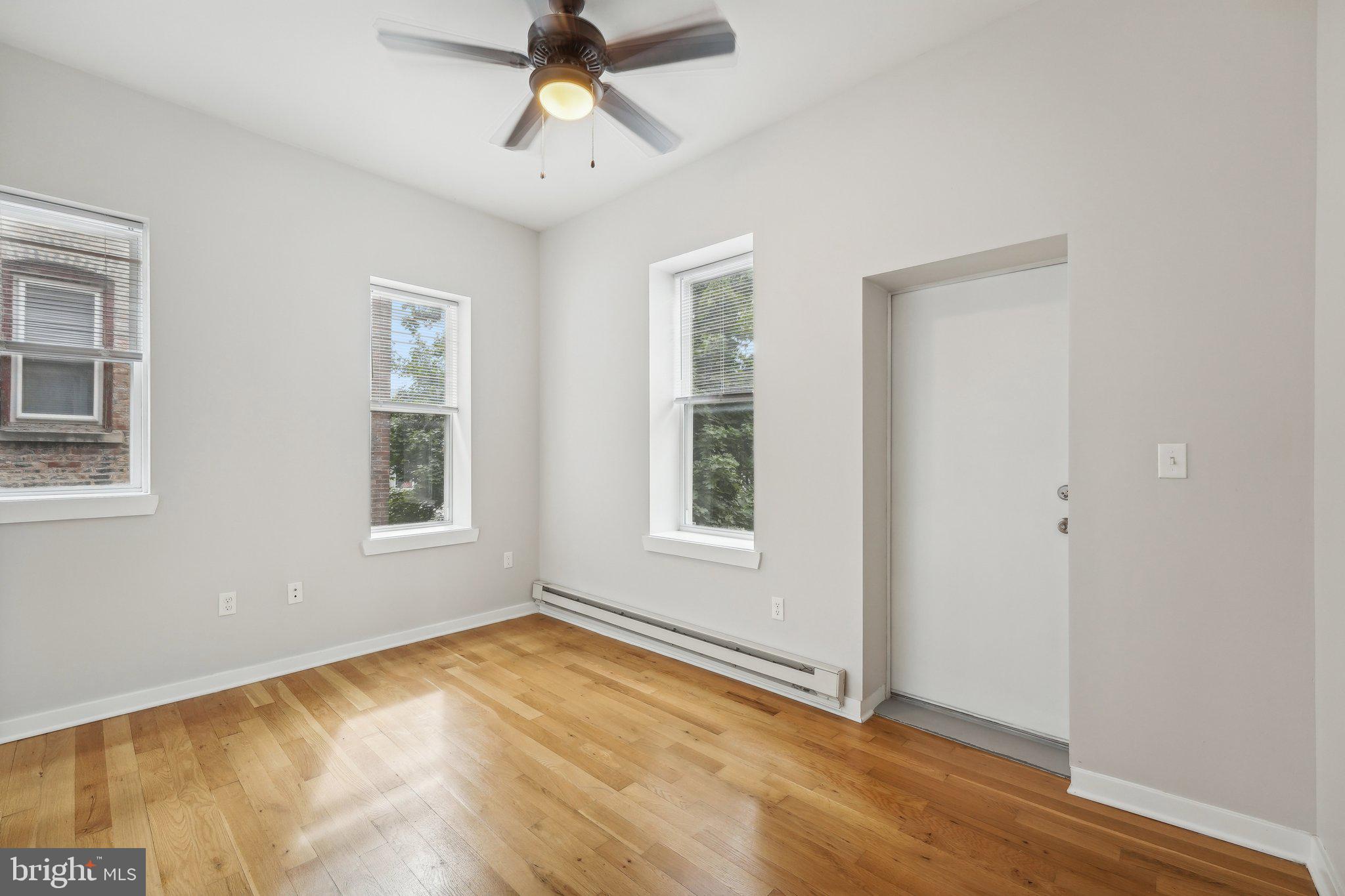 4300 Chestnut Street, Unit 2 Philadelphia, PA 19104 - Photo 20 of 30 a view of an empty room with a window and wooden floor