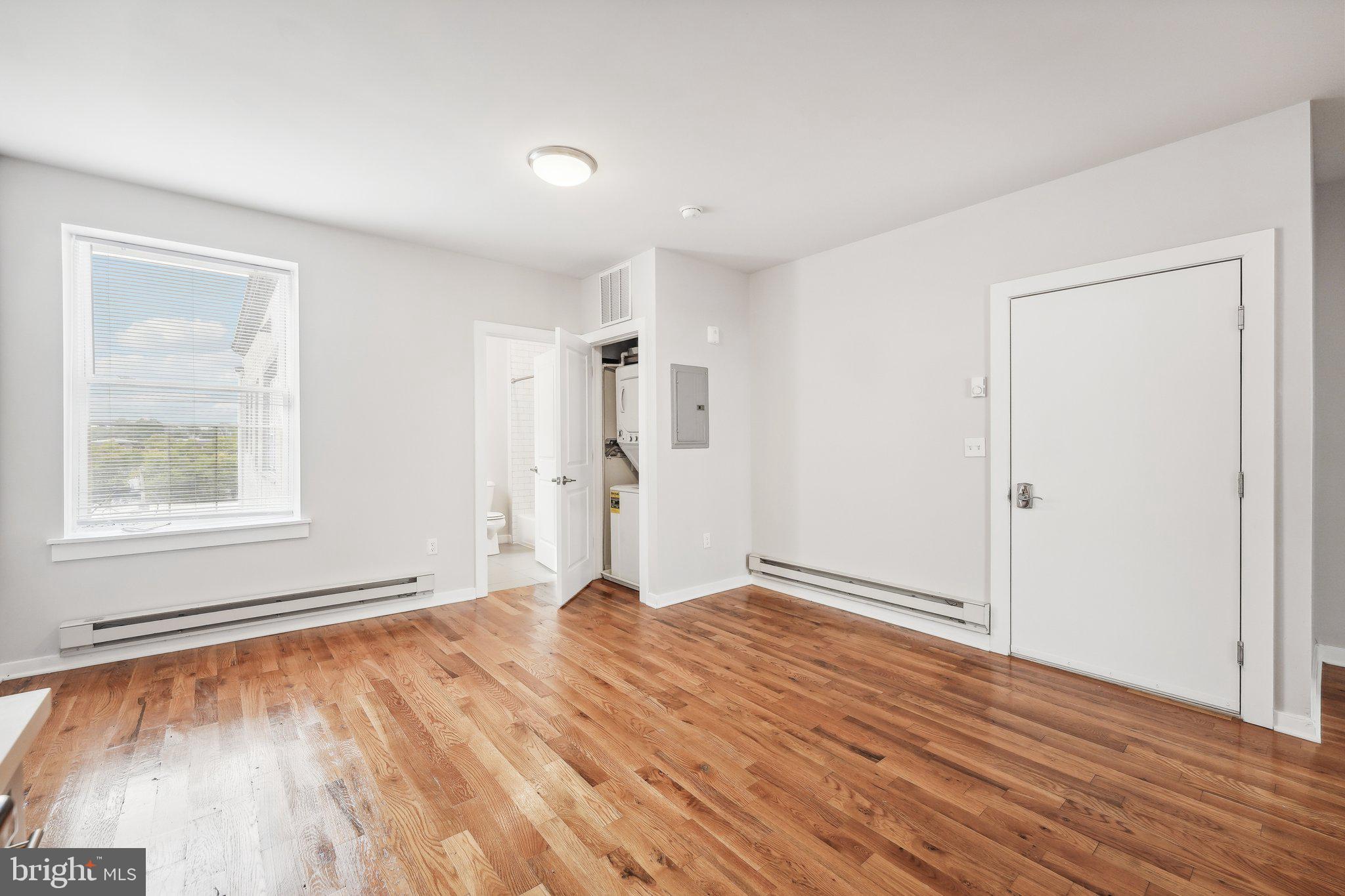 4300 Chestnut Street, Unit 2 Philadelphia, PA 19104 - Photo 23 of 30 a view of an empty room with wooden floor and a window