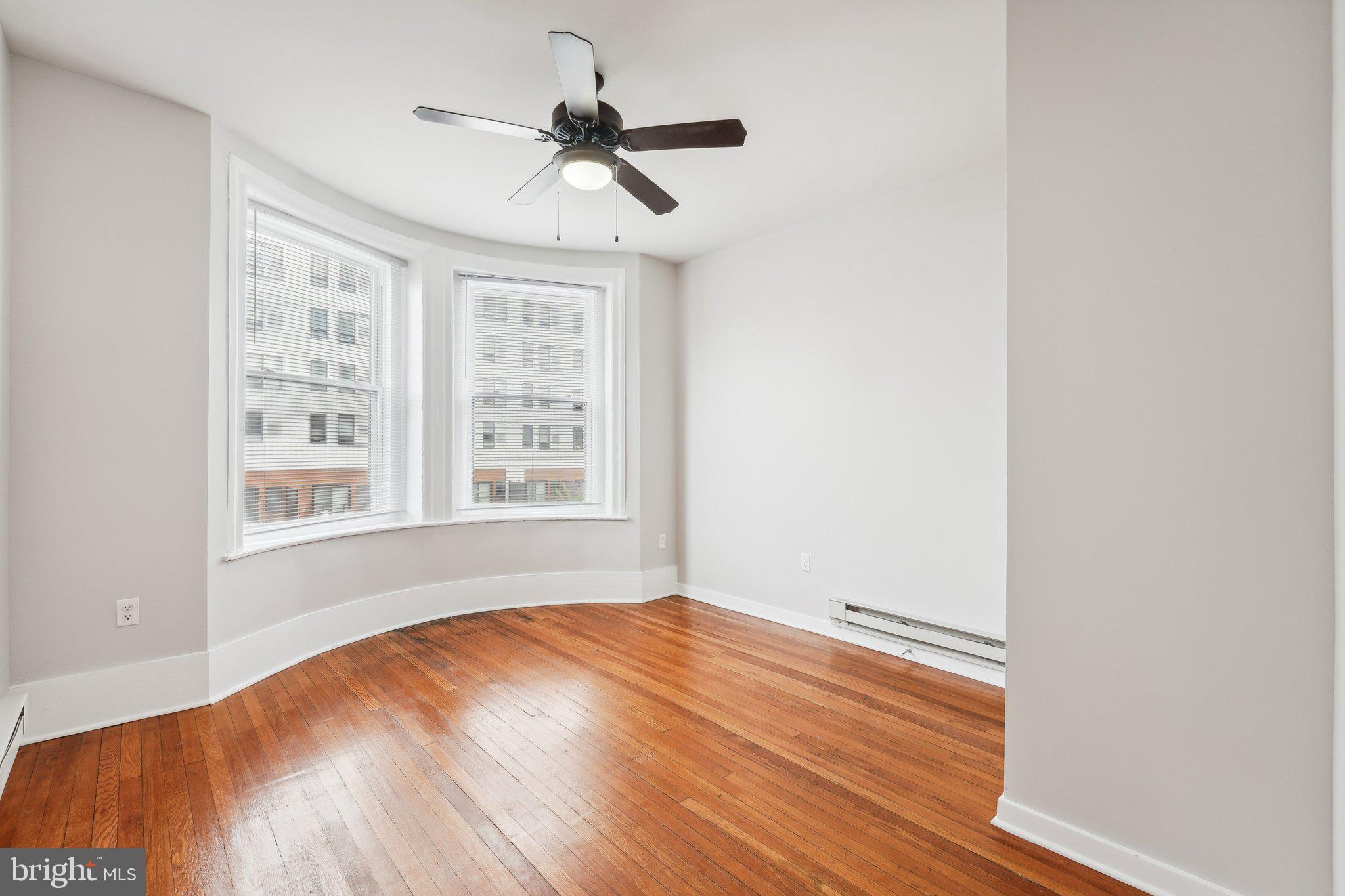 4300 Chestnut Street, Unit 2 Philadelphia, PA 19104 - Photo 25 of 30 a view of an empty room with wooden floor and a window