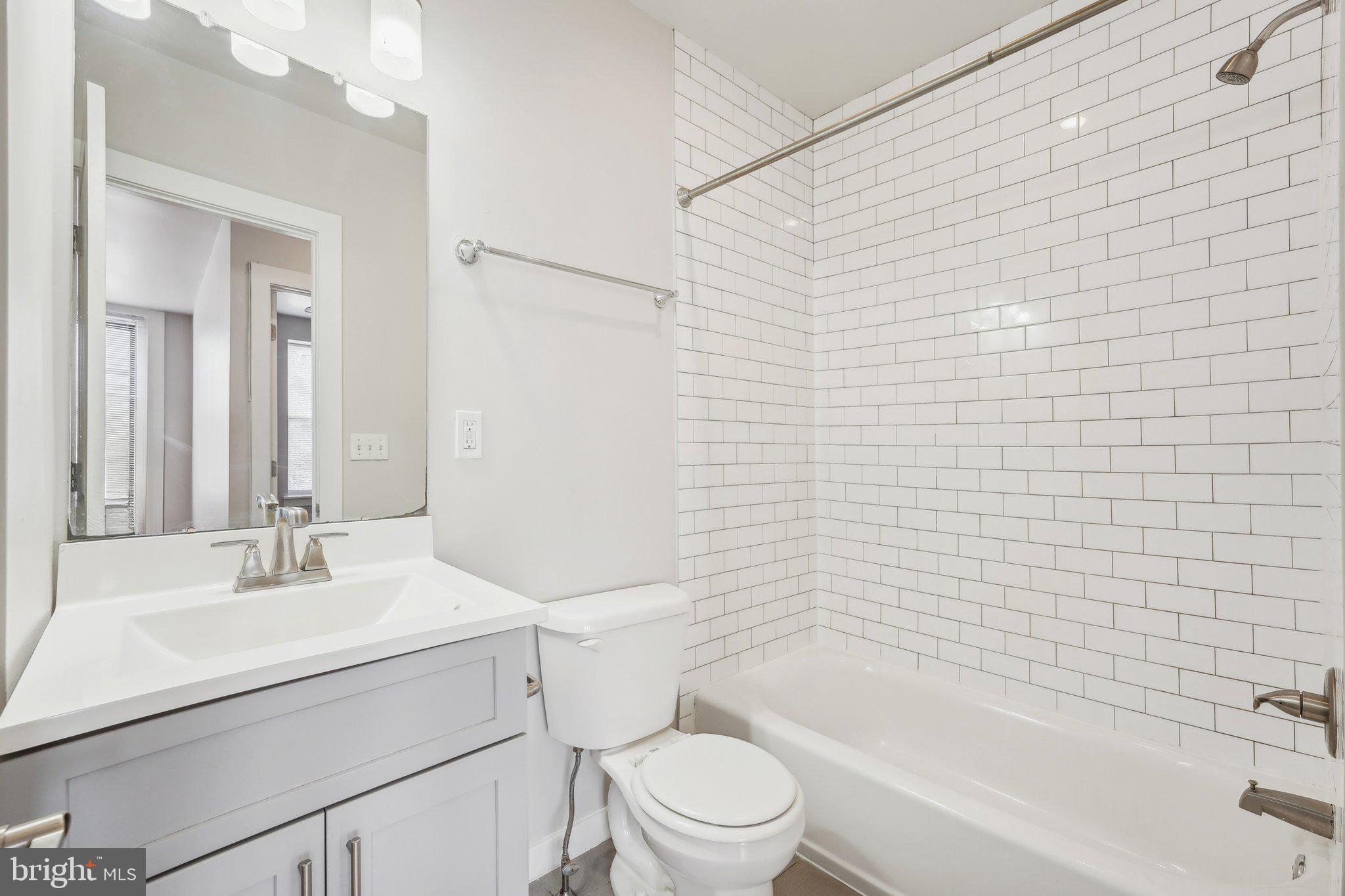 4300 Chestnut Street, Unit 2 Philadelphia, PA 19104 - Photo 3 of 30 a bathroom with a sink toilet and shower