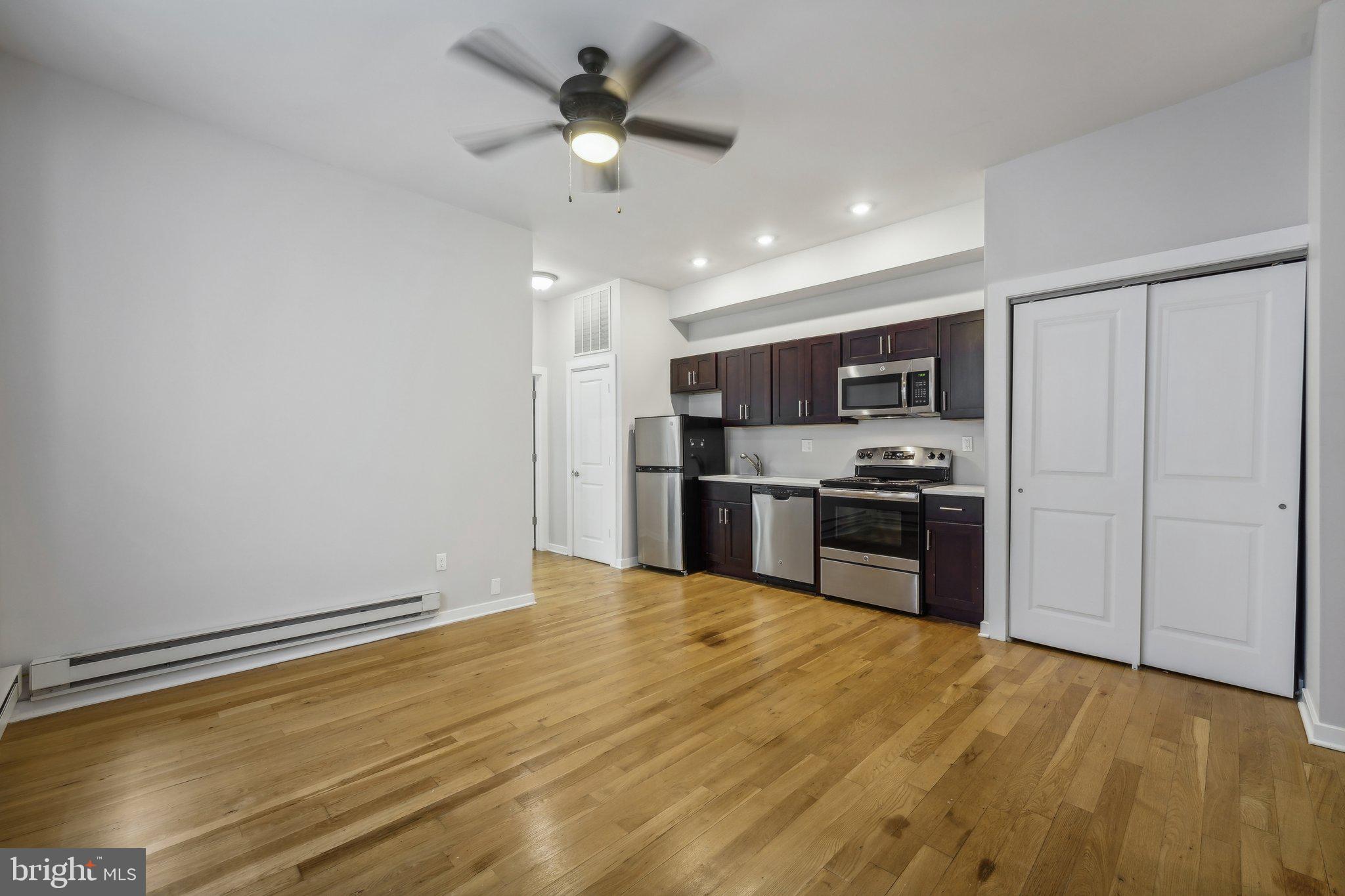 4300 Chestnut Street, Unit 2 Philadelphia, PA 19104 - Photo 5 of 30 a kitchen with stainless steel appliances granite countertop a refrigerator and a stove top oven