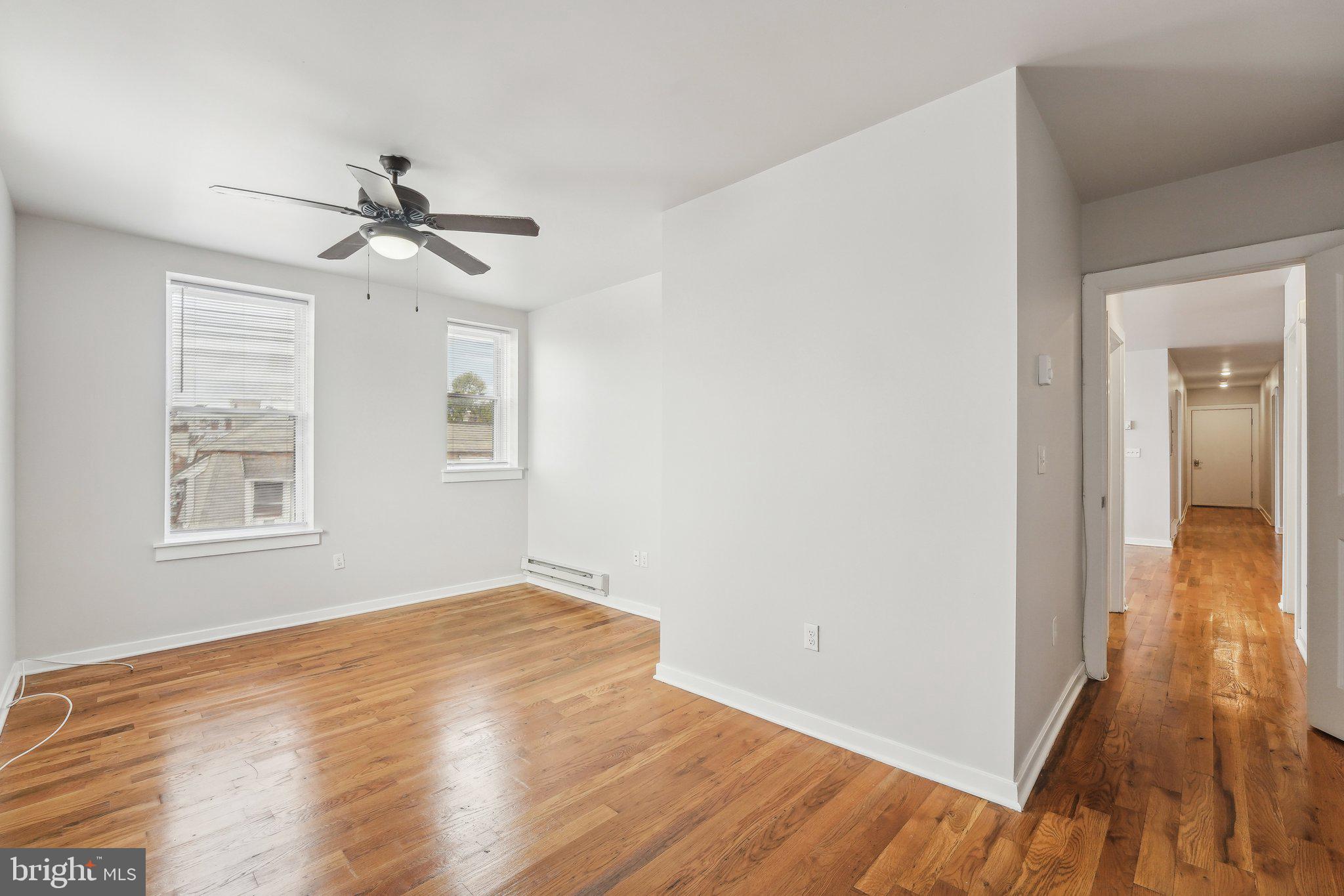 4300 Chestnut Street, Unit 2 Philadelphia, PA 19104 - Photo 10 of 30 a view of empty room with wooden floor and fan