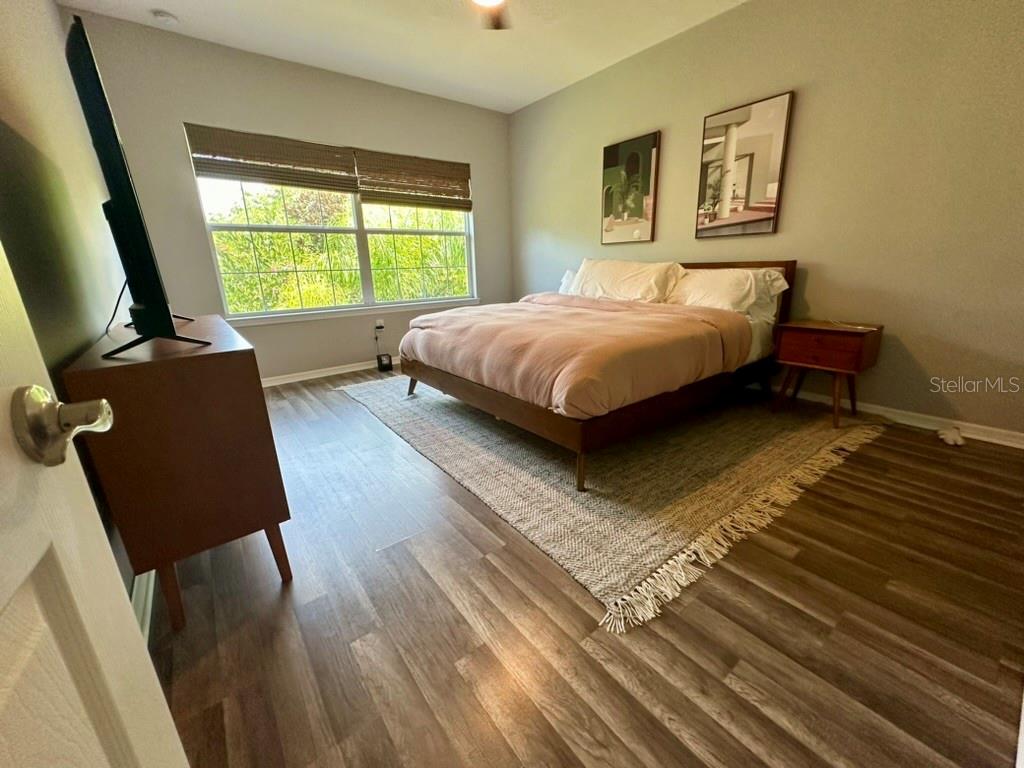 80 Navigation Circle Osprey, FL 34229 - Photo 15 of 36 a bedroom with a bed window and painting on the wall