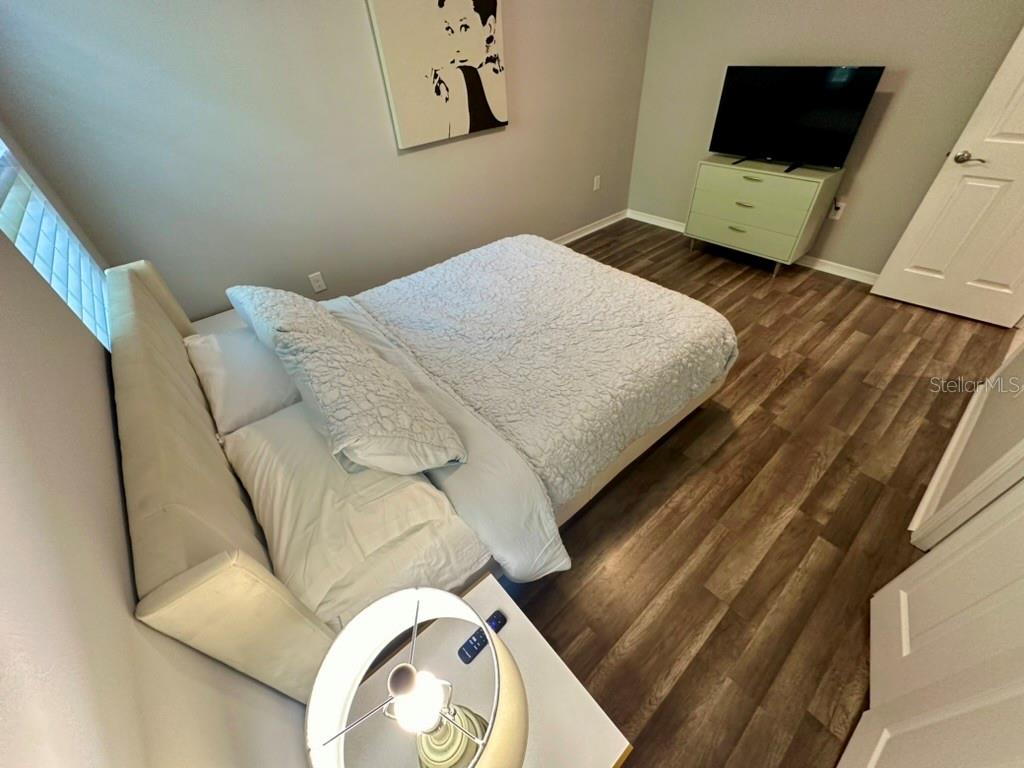 80 Navigation Circle Osprey, FL 34229 - Photo 19 of 36 a bedroom with a bed and a flat screen tv