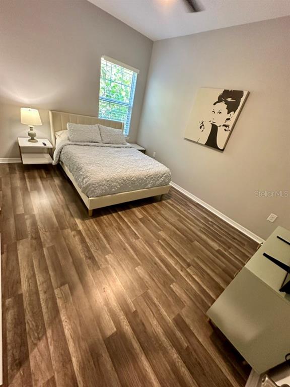 80 Navigation Circle Osprey, FL 34229 - Photo 20 of 36 a bedroom with a bed and wooden floor