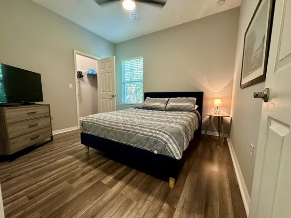 a bedroom with a bed and flat screen tv