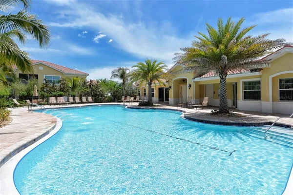 a view of a house with swimming pool and sitting area