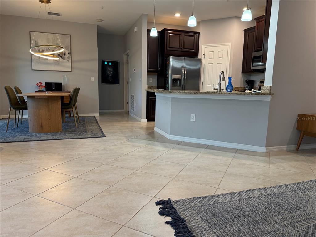 80 Navigation Circle Osprey, FL 34229 - Photo 6 of 36 a kitchen with stainless steel appliances kitchen island granite countertop a sink and cabinets