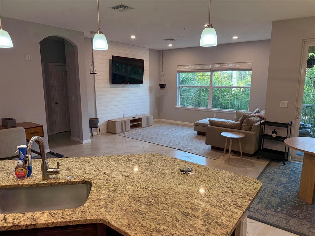 80 Navigation Circle Osprey, FL 34229 - Photo 9 of 36 a kitchen with kitchen island granite countertop a sink and a counter top space